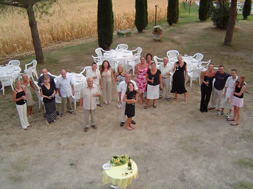 Large group enjoying pre-dinner drinks on holiday in Italy for a birthday celebration